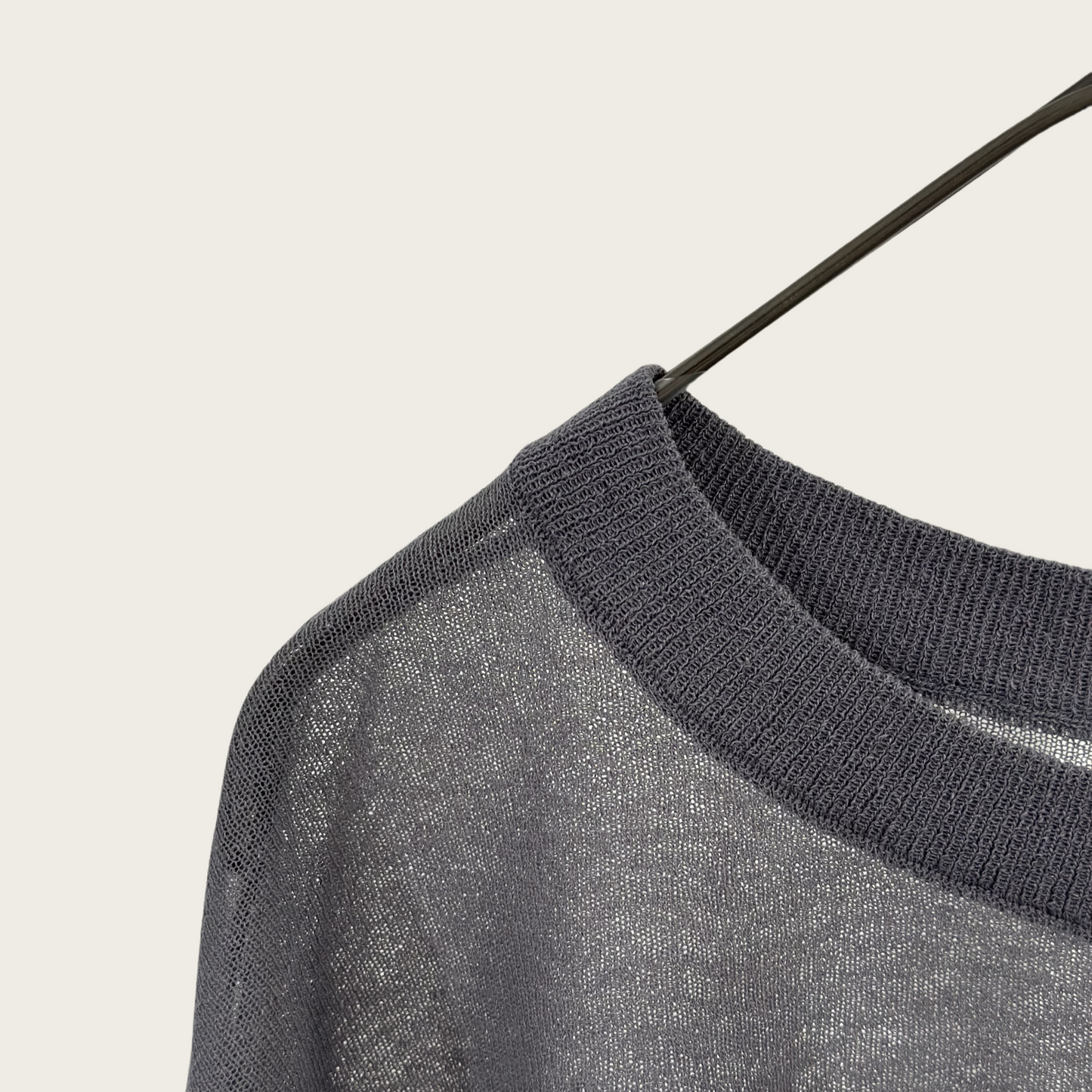 Semi-sheer crew neck pullover knit top with a slightly longer fit.