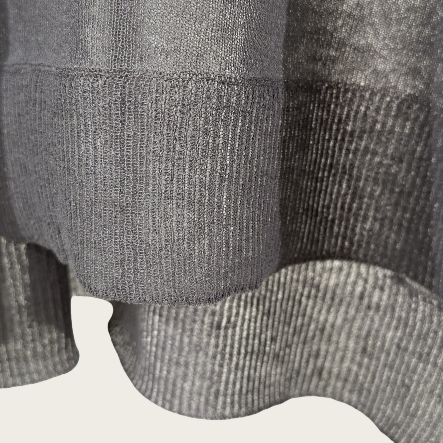 Semi-sheer crew neck pullover knit top with a slightly longer fit.