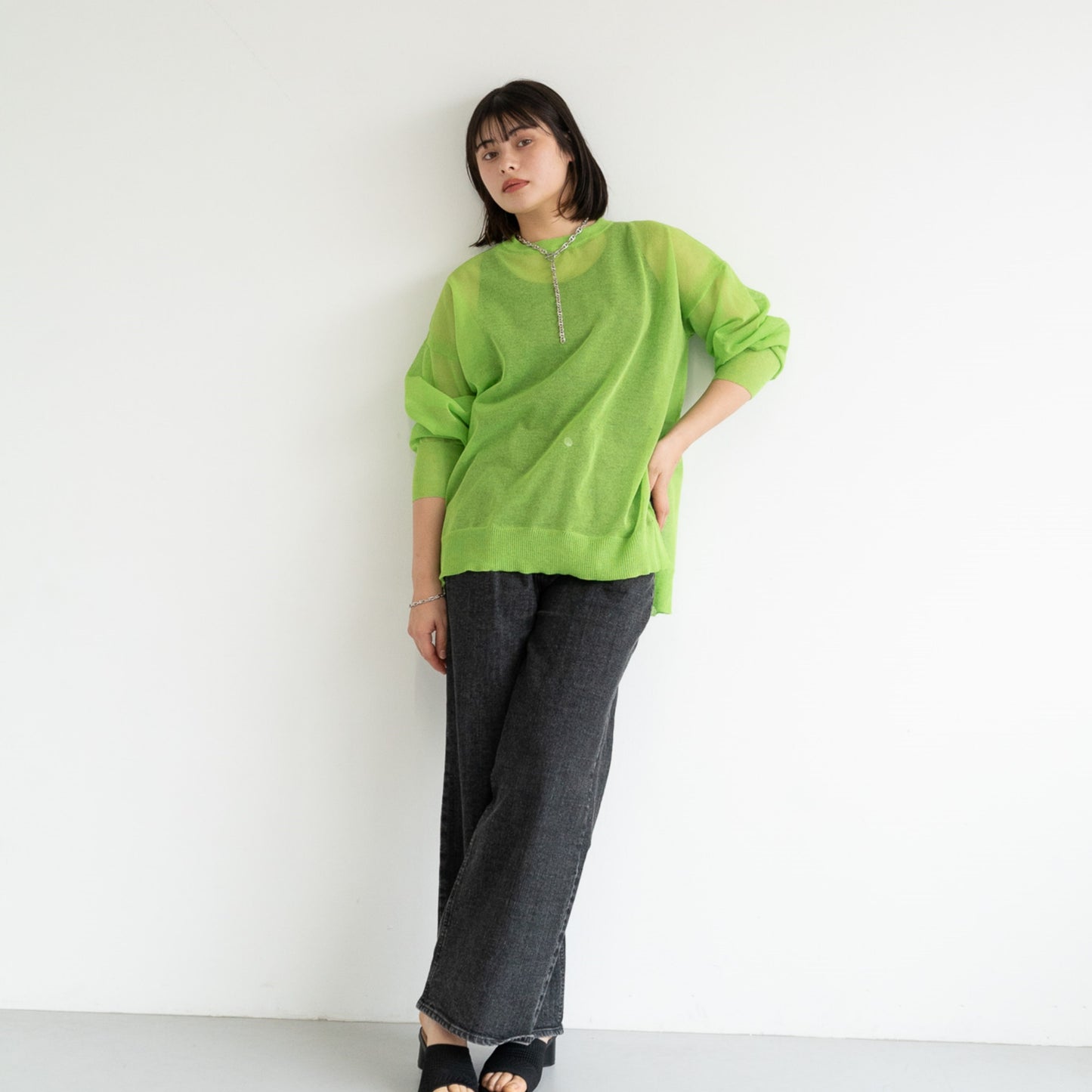 Semi-sheer crew neck pullover knit top with a slightly longer fit.