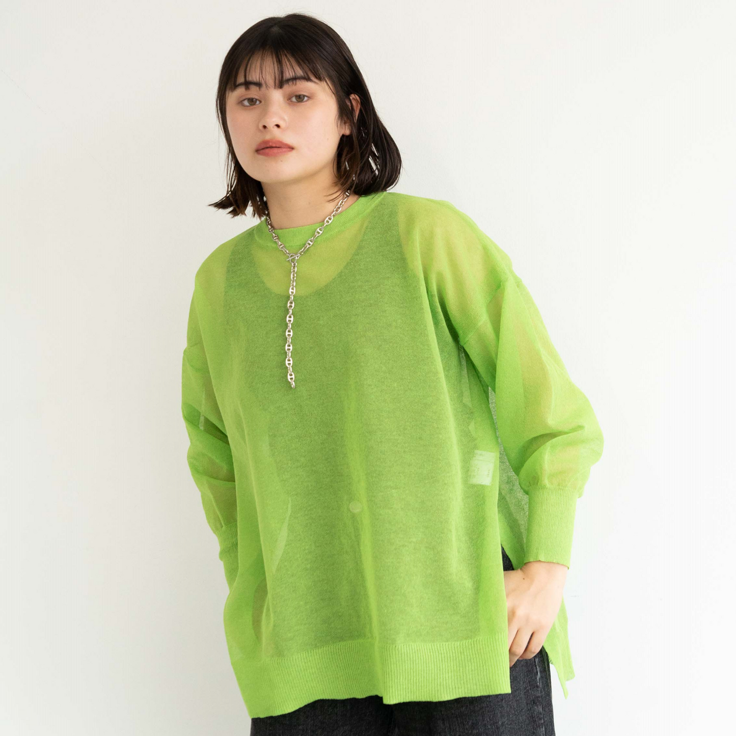 Semi-sheer crew neck pullover knit top with a slightly longer fit.