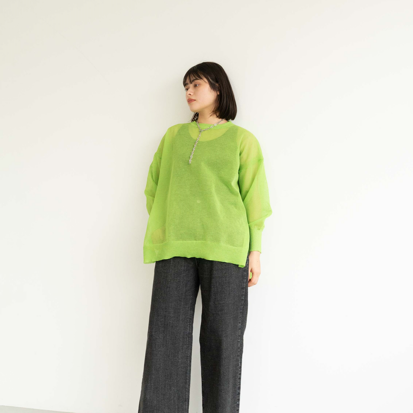 Semi-sheer crew neck pullover knit top with a slightly longer fit.