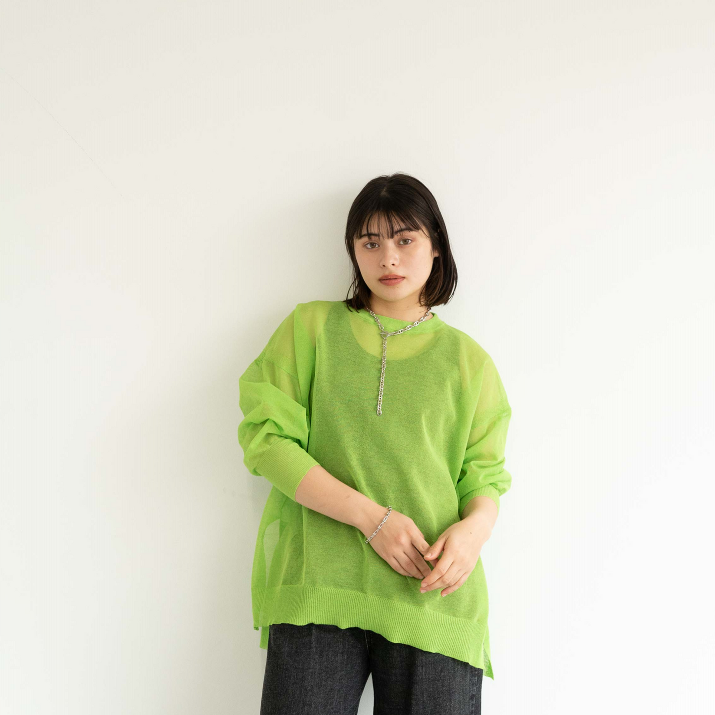 Semi-sheer crew neck pullover knit top with a slightly longer fit.