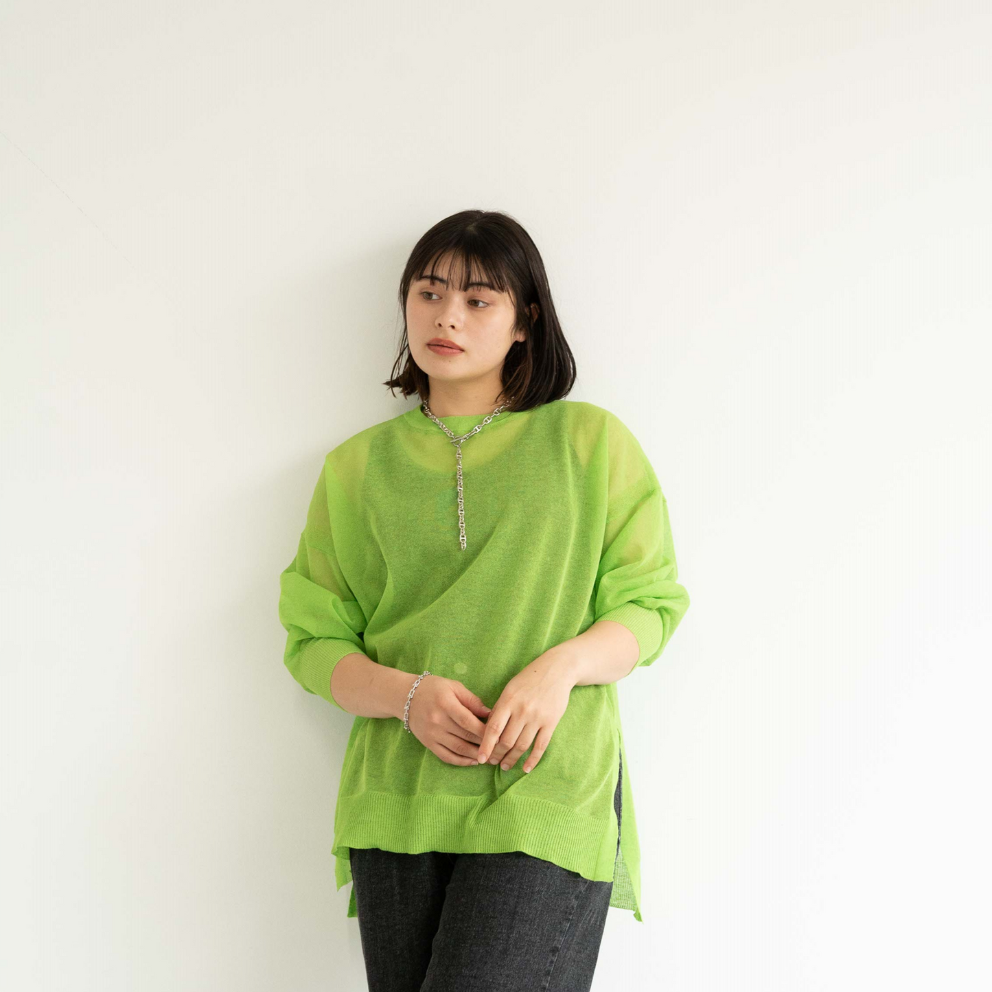 Semi-sheer crew neck pullover knit top with a slightly longer fit.