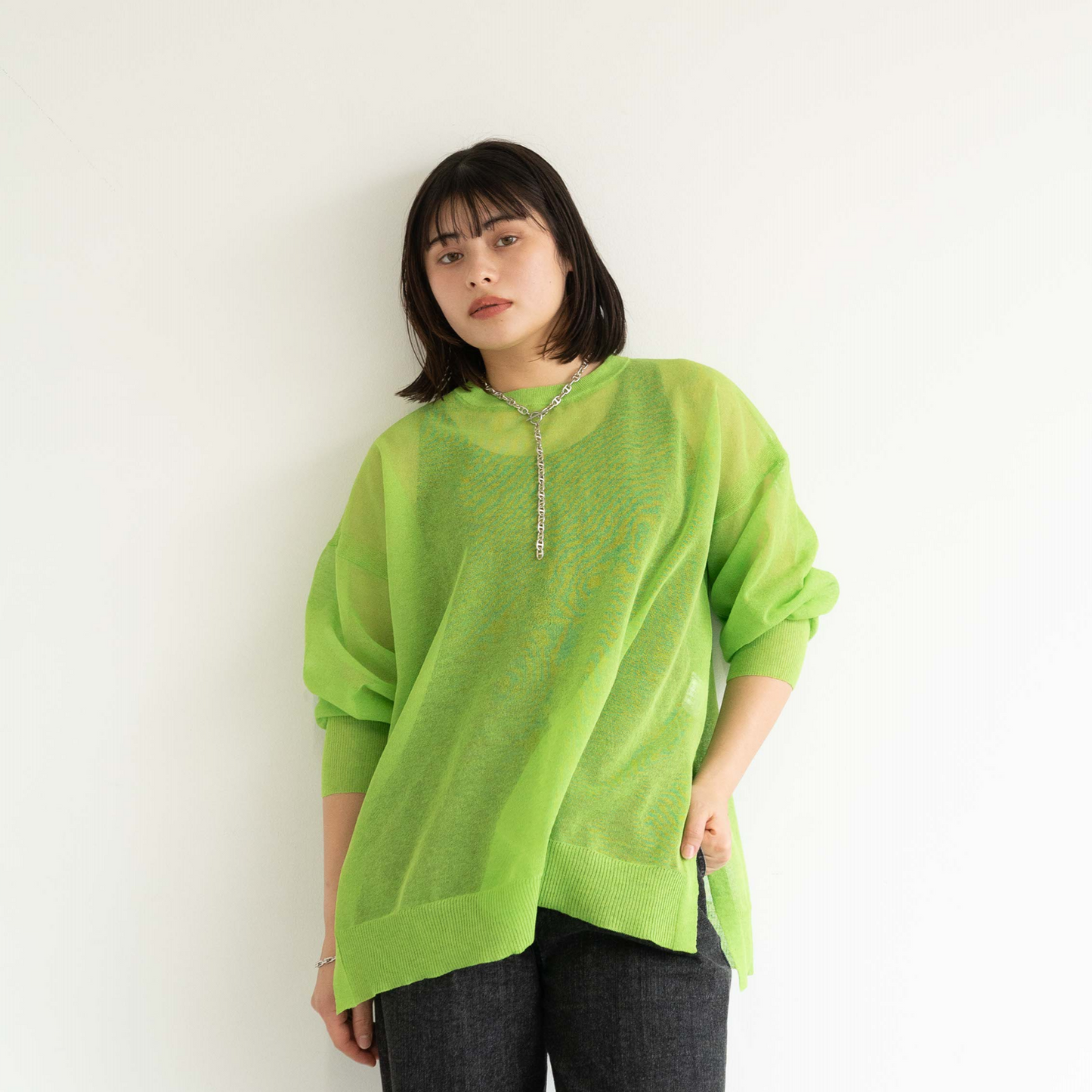 Semi-sheer crew neck pullover knit top with a slightly longer fit.