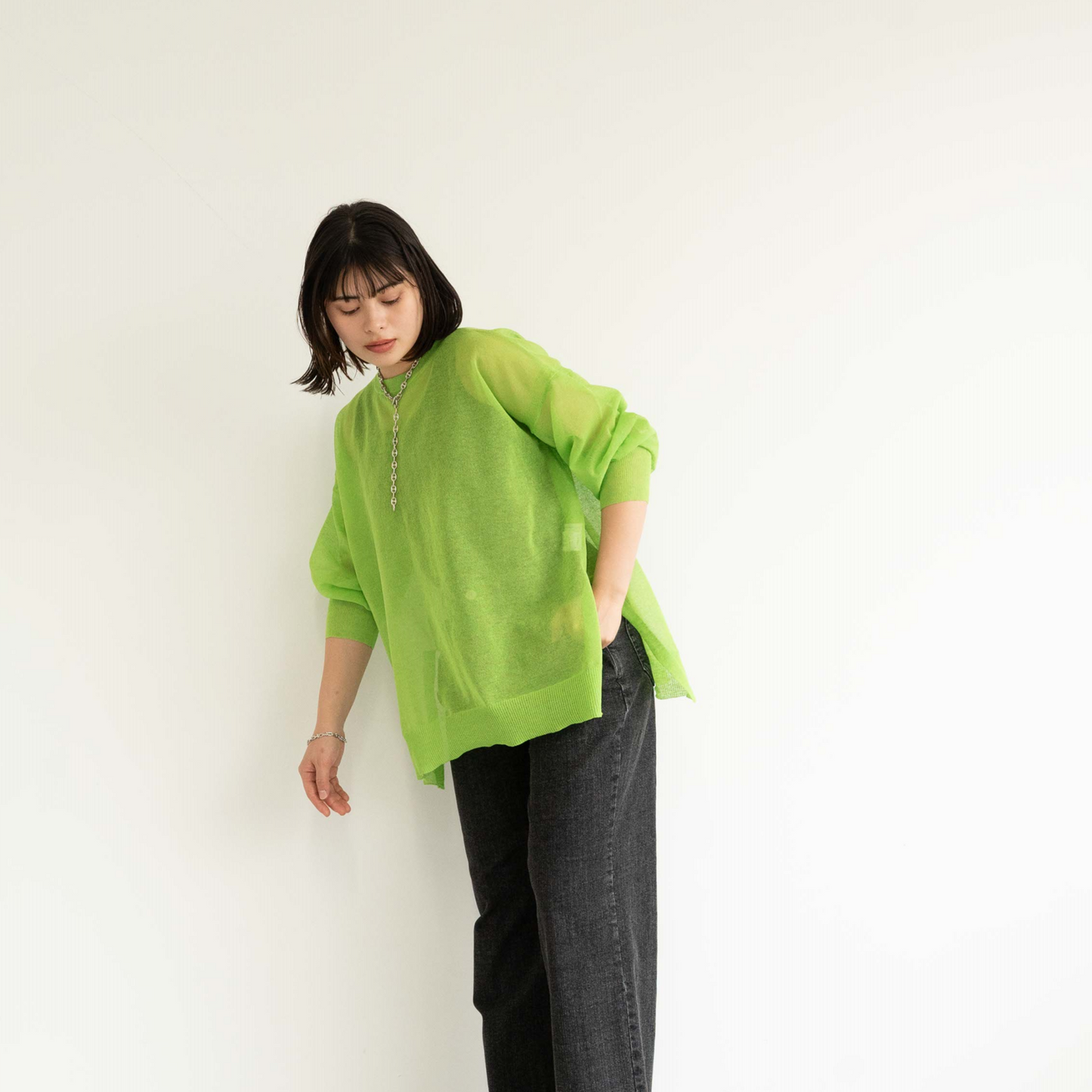 Semi-sheer crew neck pullover knit top with a slightly longer fit.
