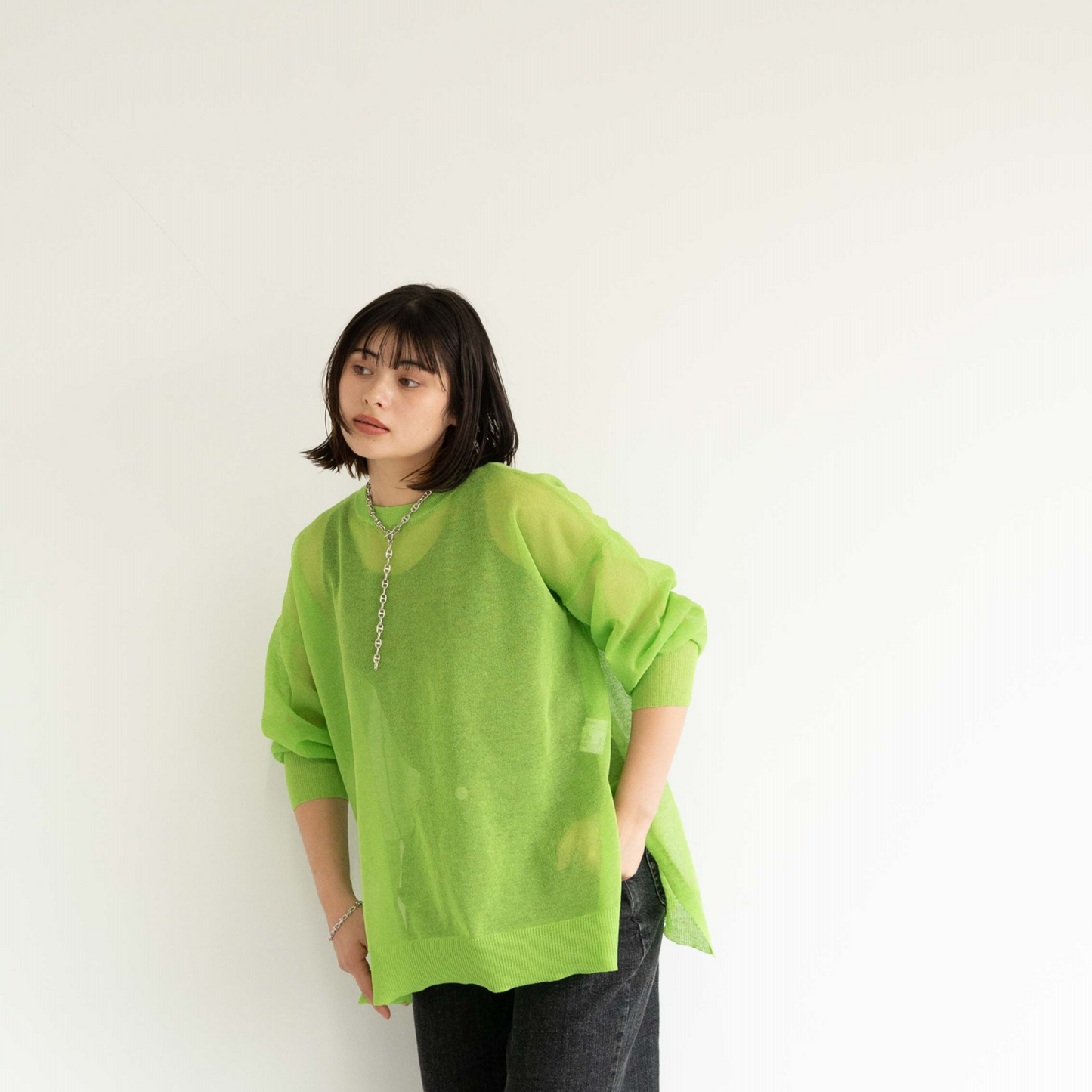 Semi-sheer crew neck pullover knit top with a slightly longer fit.