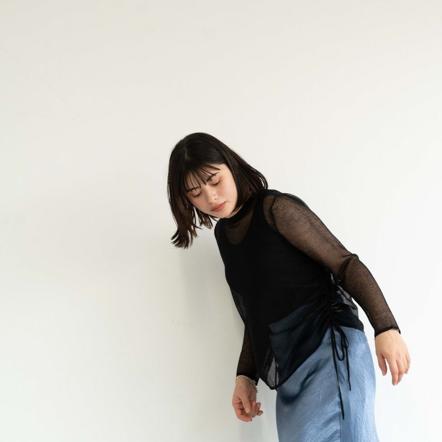 14-gauge knit pullover with drawstring knit details on both sides