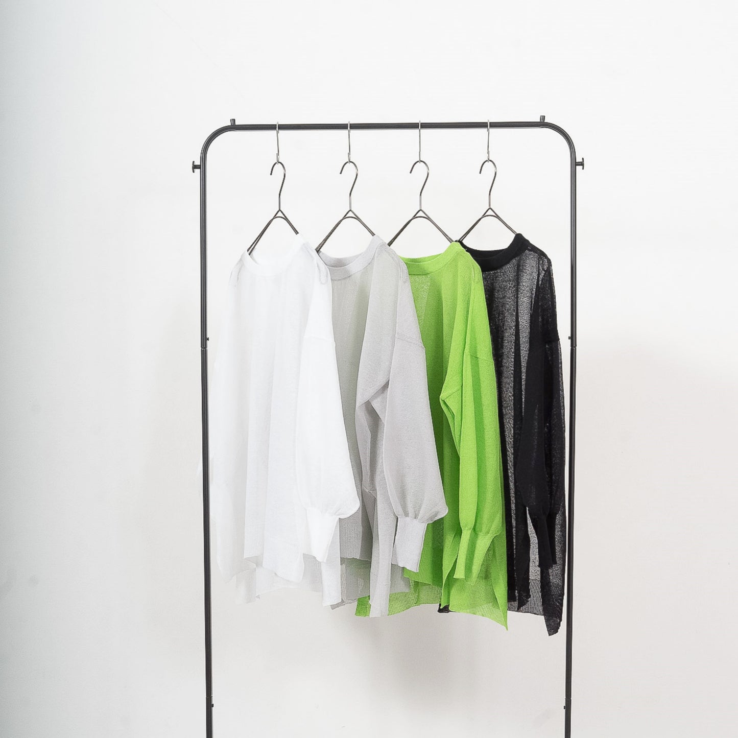 Semi-sheer crew neck pullover knit top with a slightly longer fit.